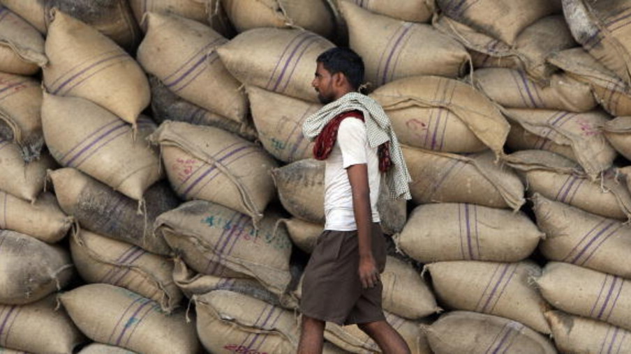 A labourer walks past sacks of sugar at a warehouse in Mumbai on April 21, 2008.  India's battle against spiralling inflation is not over yet, but more monetary tightening could put the brakes on growth in Asia's third-largest economy, analysts have warned.  The central bank has told commercial banks to hike cash reserves to suck out excess money supply in an effort to cool inflation that has more than doubled in four months to touch a three-year high of 7.14 percent.  AFP PHOTO/ Indranil MUKHERJEE (Photo credit should read INDRANIL MUKHERJEE/AFP/Getty Images)