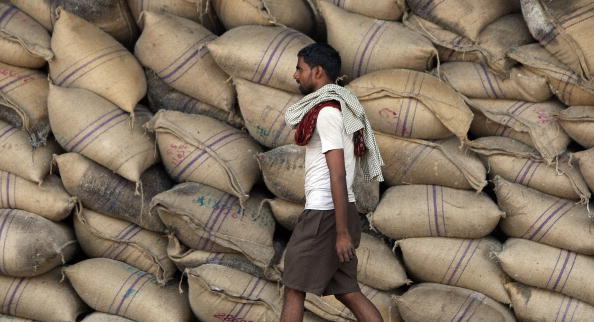 A labourer walks past sacks of sugar at a warehouse in Mumbai on April 21, 2008.  India's battle against spiralling inflation is not over yet, but more monetary tightening could put the brakes on growth in Asia's third-largest economy, analysts have warned.  The central bank has told commercial banks to hike cash reserves to suck out excess money supply in an effort to cool inflation that has more than doubled in four months to touch a three-year high of 7.14 percent.  AFP PHOTO/ Indranil MUKHERJEE (Photo credit should read INDRANIL MUKHERJEE/AFP/Getty Images)